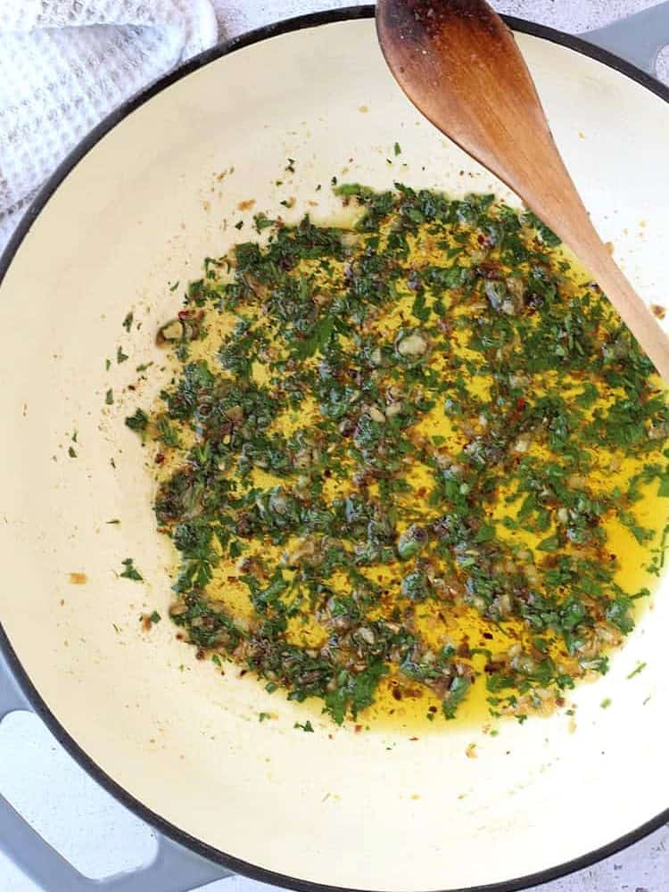 Anchovies with garlic and parsley in skillet for pasta with anchovies recipe.