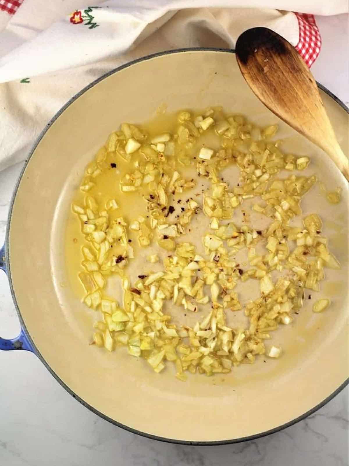 Onion sautéed in olive oil in large skillet.