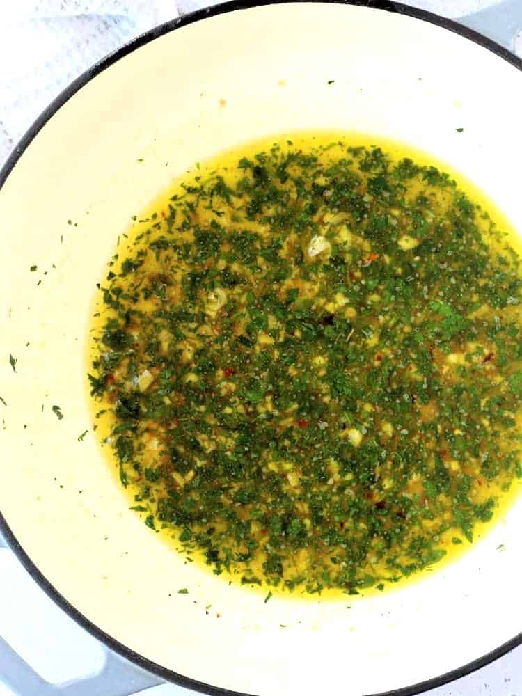 Pasta water added to skillet with anchovies, garlic and parsley.