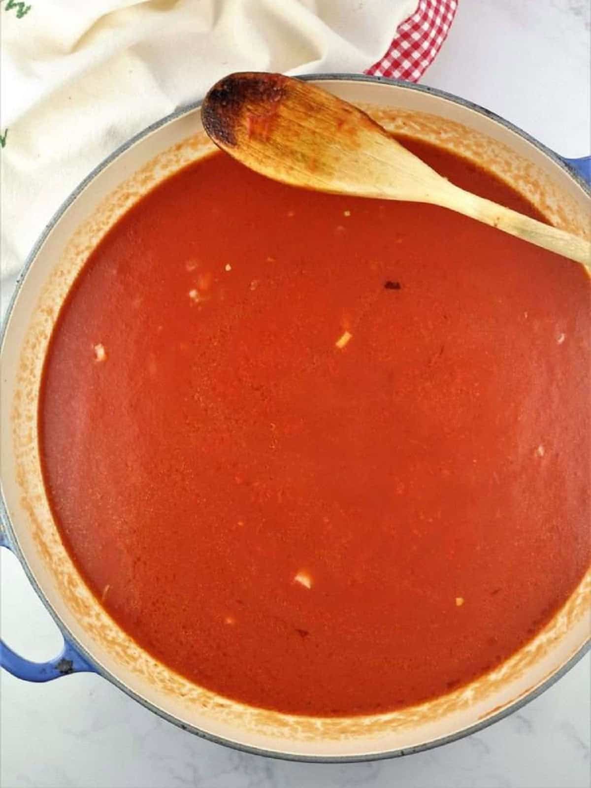 Tomato sauce in large skillet for meatless meatballs.