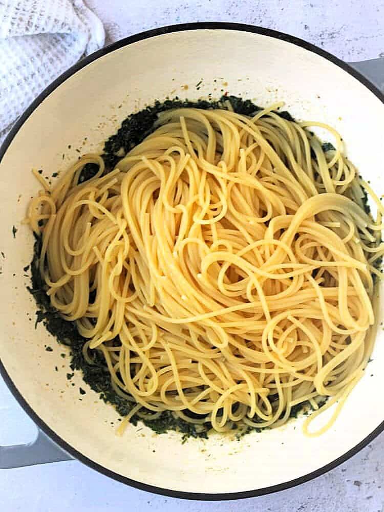 Spagthetti added to pan with anchovy sauce.