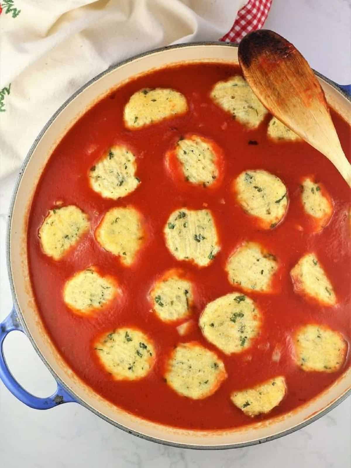 Meatless meatballs nestled in tomato sauce in large skillet.