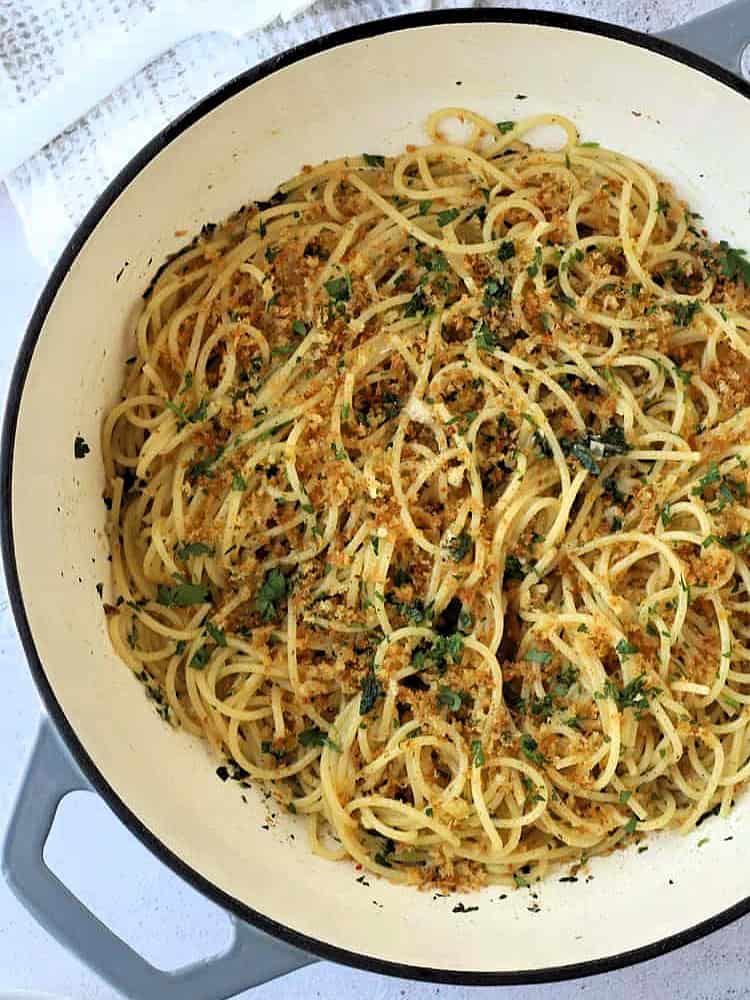Spaghetti with anchovies and breadcrumbs in skillet.