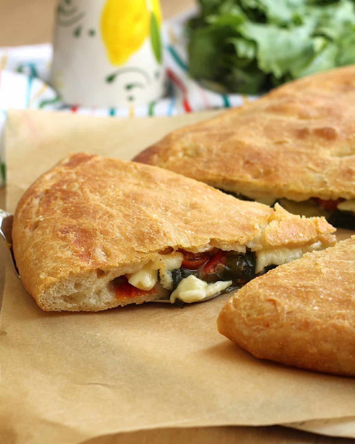 Scacciata recipe with escarole, cherry tomatoes and tuma cheese.