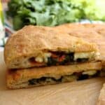 Sicilian scacciata Messinese filled with escarole, cherry tomatoes and tuma cheese.