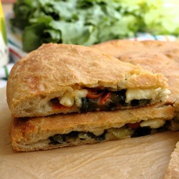 Sicilian scacciata Messinese filled with escarole, cherry tomatoes and tuma cheese.