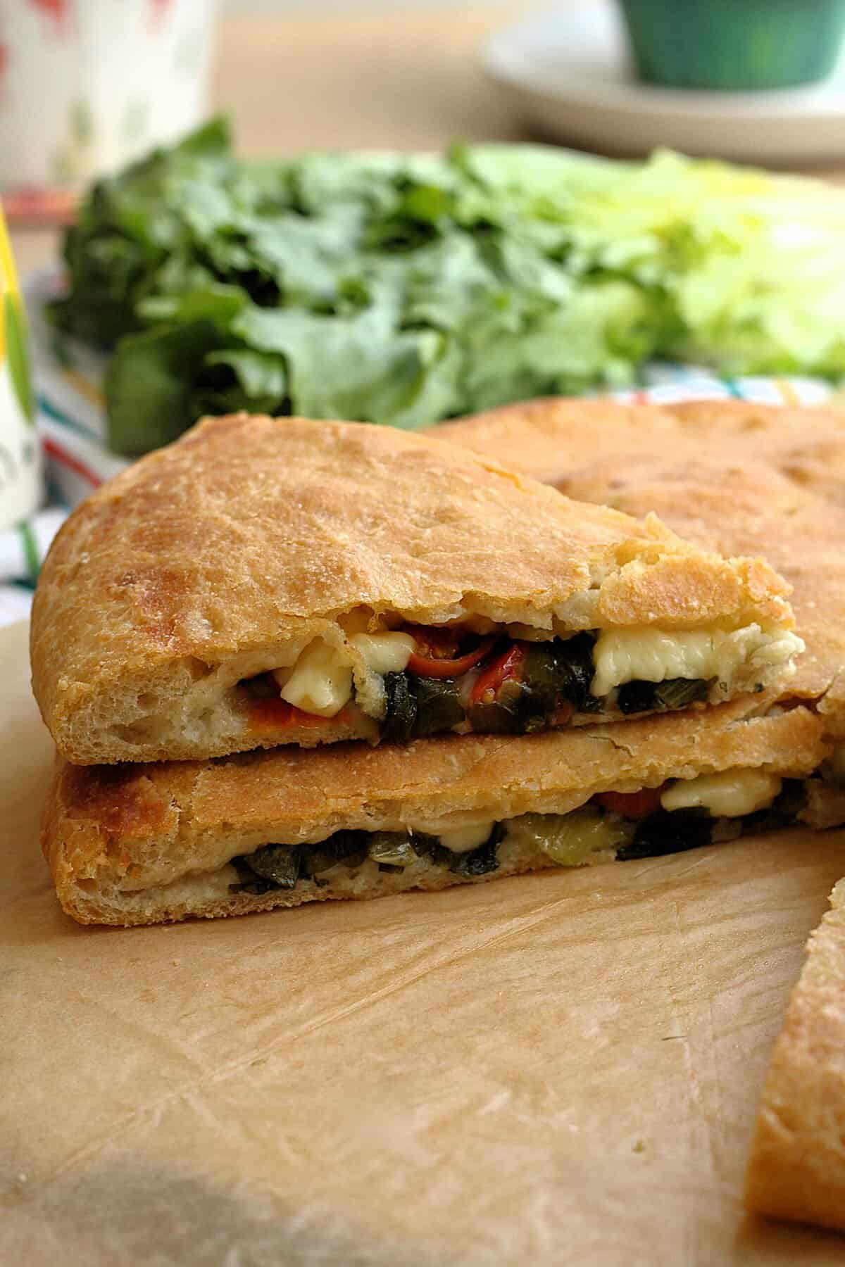 Sicilian scacciata Messinese filled with escarole, cherry tomatoes and tuma cheese.