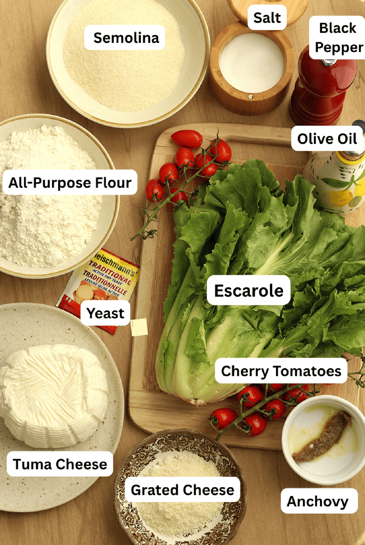 Escarole, tuma cheese, cherry tomatoes, anchovy, grated cheese, flour, semolina, yeast, salt, pepper and olive oil.