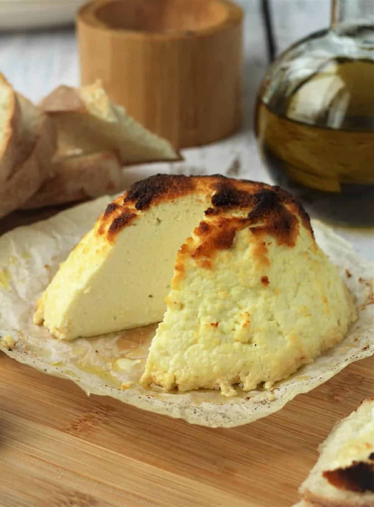 Ricotta infornata with wedge cut out.