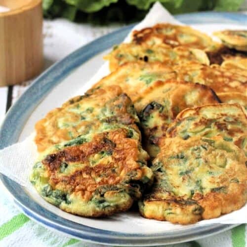 Fritters with swiss chard on serving plate.