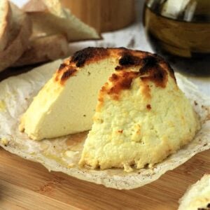 Baked ricotta with wedge cut out.