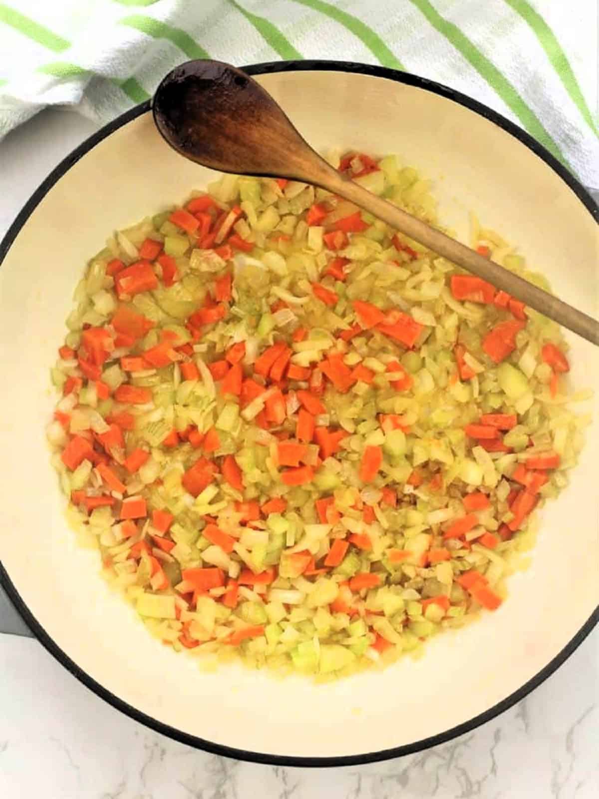 Diced onion, carrots and celery sautéed in skillet for ragu recipe.
