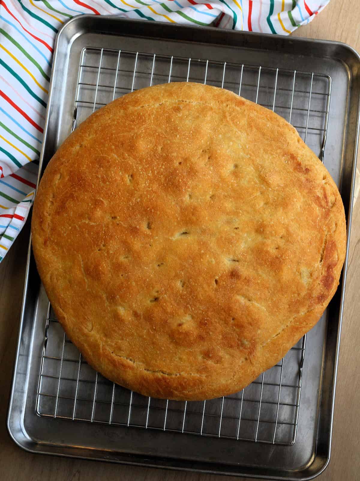 Baked scacciata Messinese resting on wire rack.