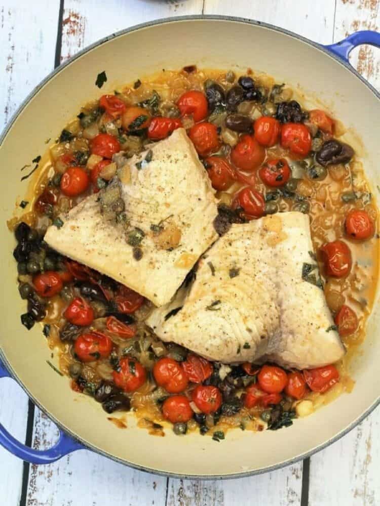 Swordfish fillets added to pan with cherry tomatoes, olives and capers.