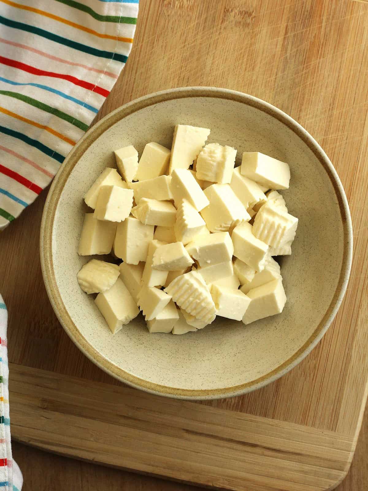 Cubed tuma cheese in bowl for scacciata filling.