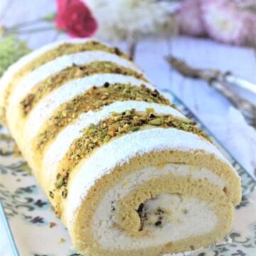 Ricotta pistachio roll cake on plate.