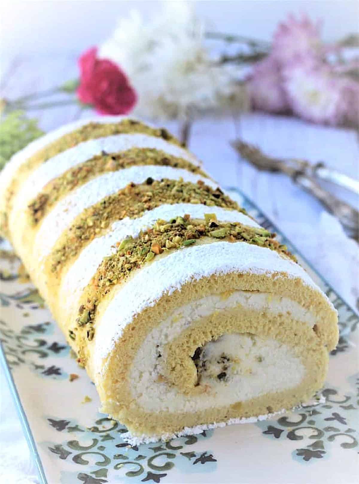 Ricotta pistachio roll cake on plate.