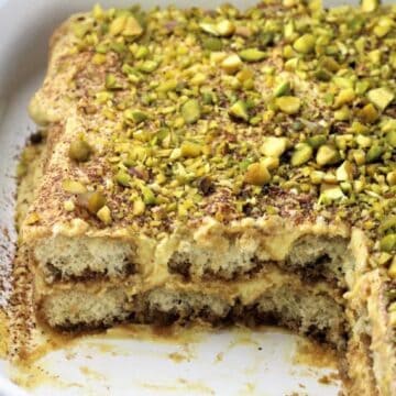 Pistachio tiramisu in white casserole dish.