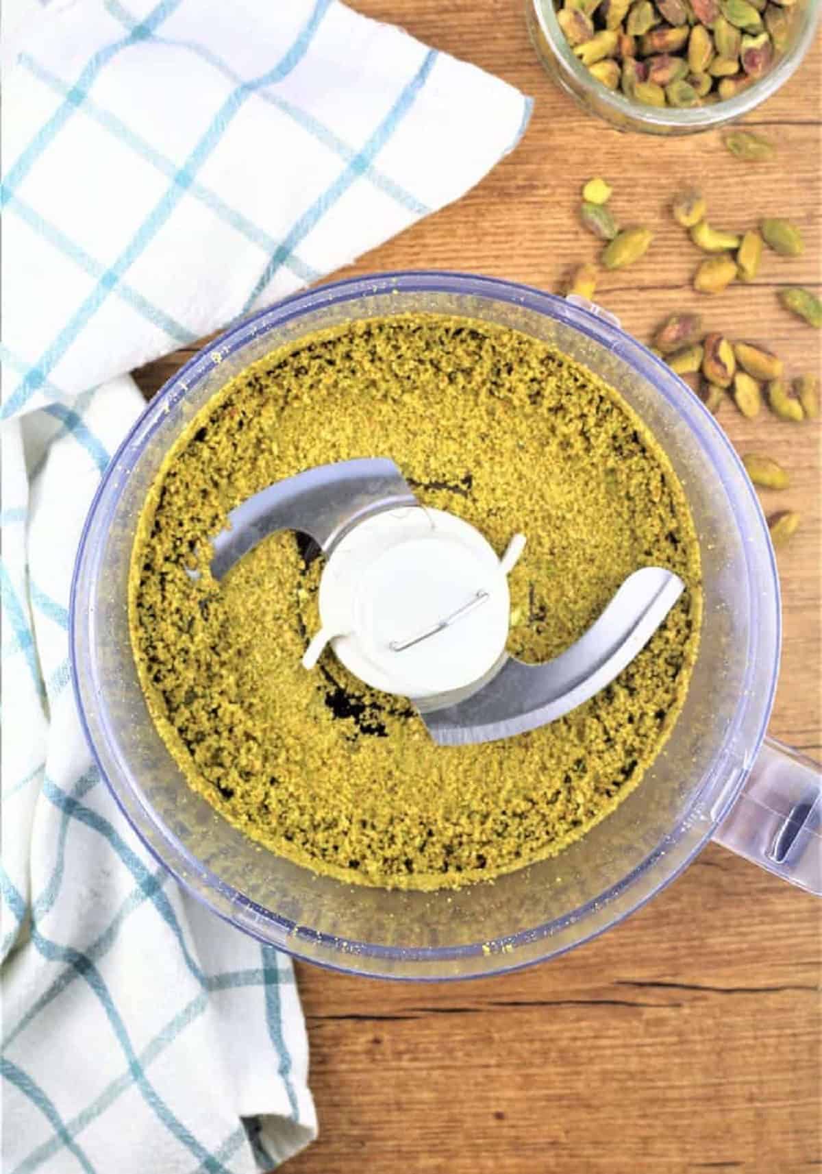 Pistachios processed in food processor bowl to make pistachio butter.