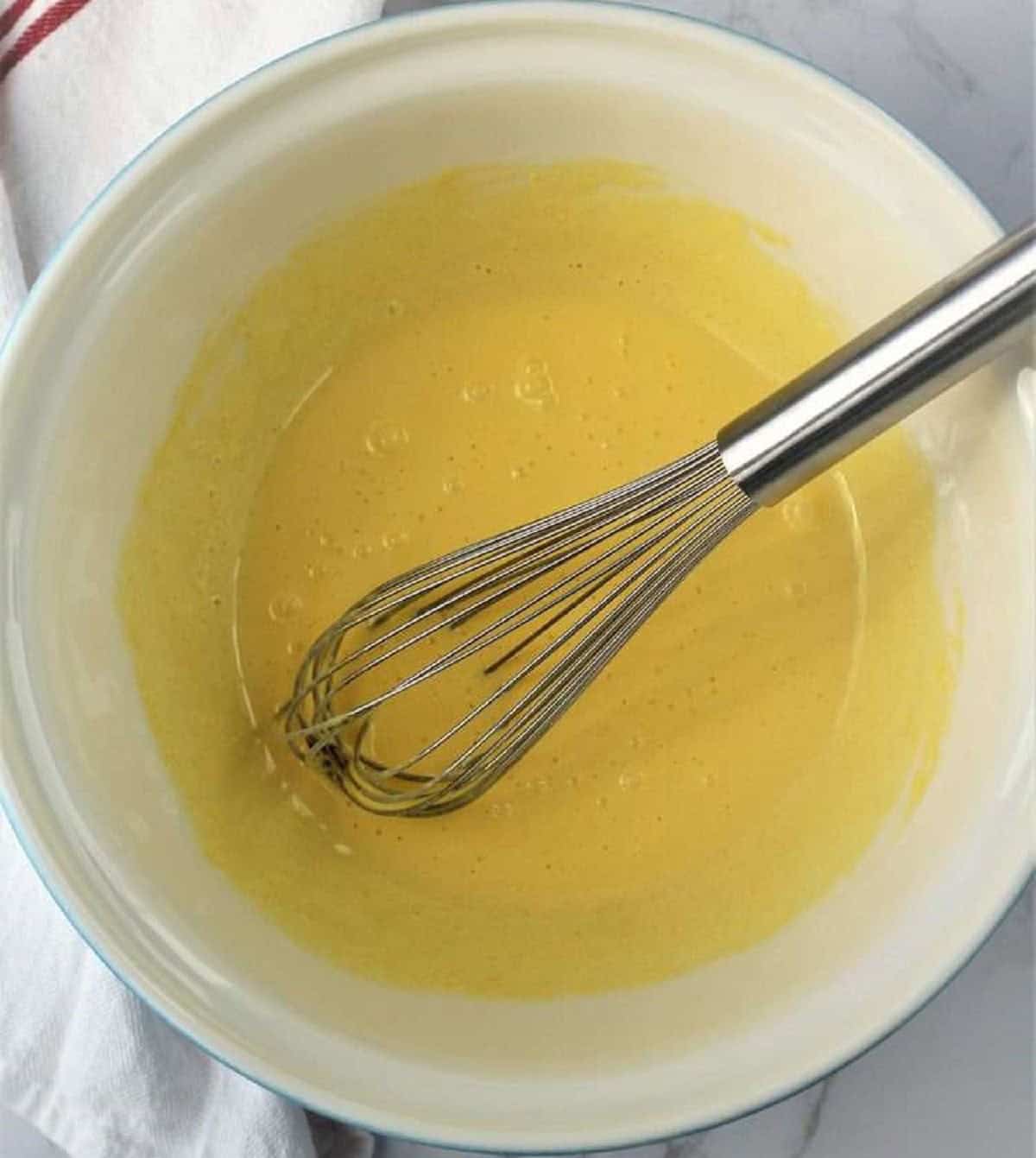 Whisked eggs and sugar for roll cake with ricotta recipe.