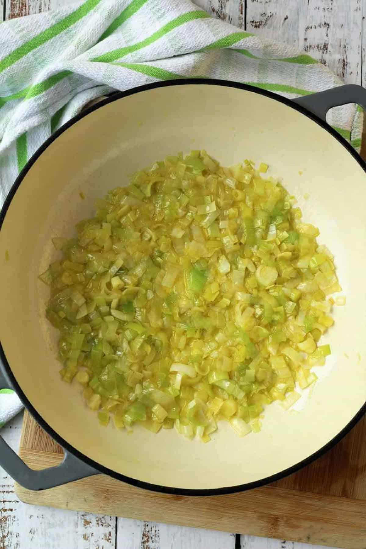Chopped leeks sautéed in olive oil in skillet.