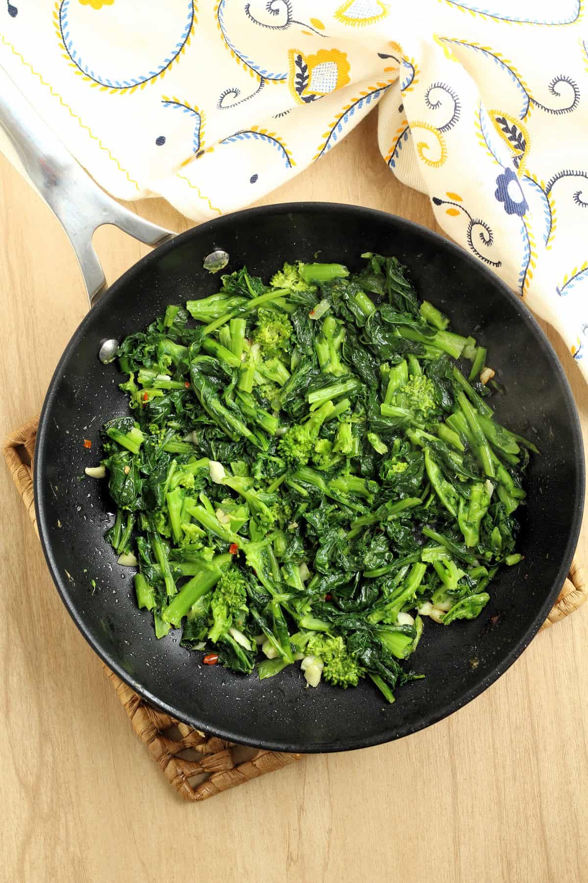 Sautéed rapini with garlic in skillet.