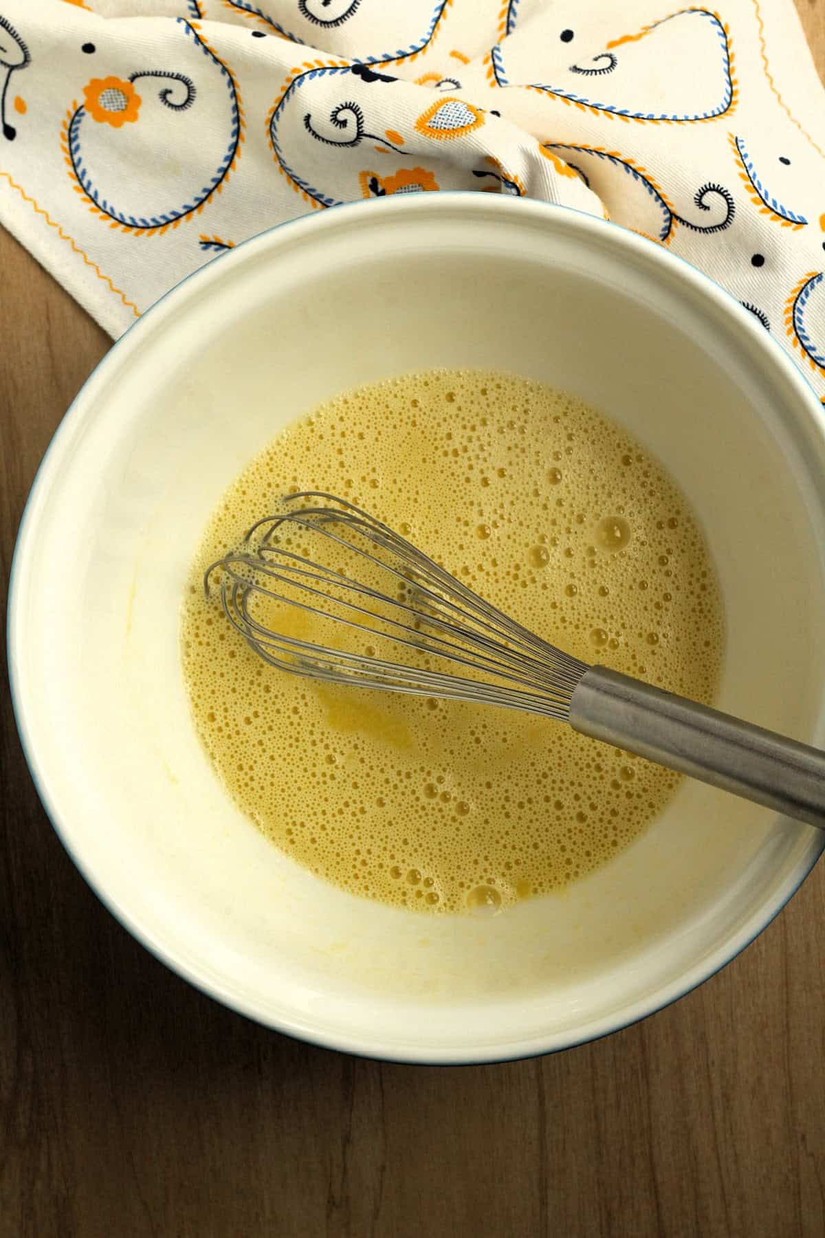 Whisked eggs, oil and milk in large mixing bowl.