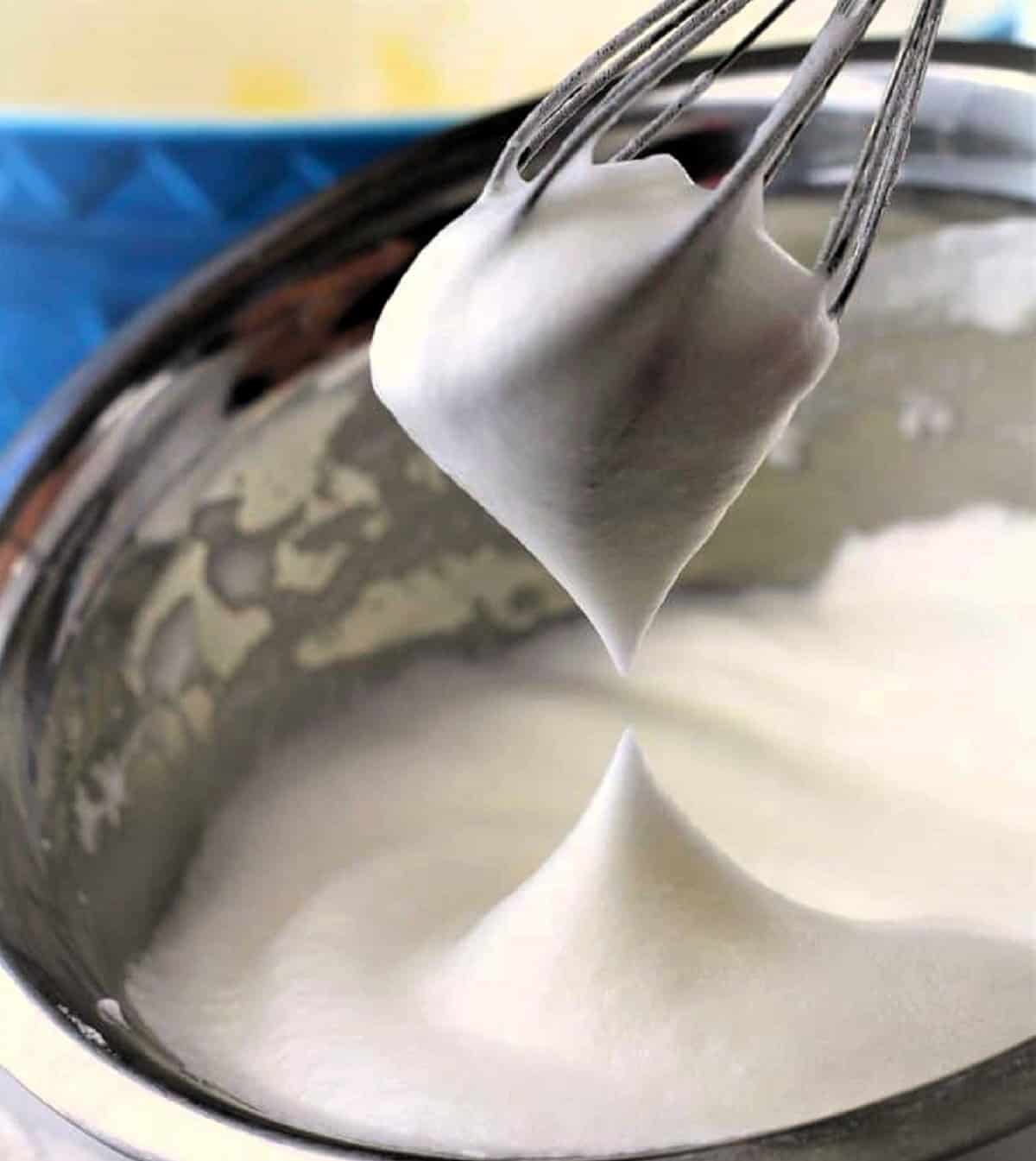 Whisked egg whites until stiff in bowl for roll cake recipe