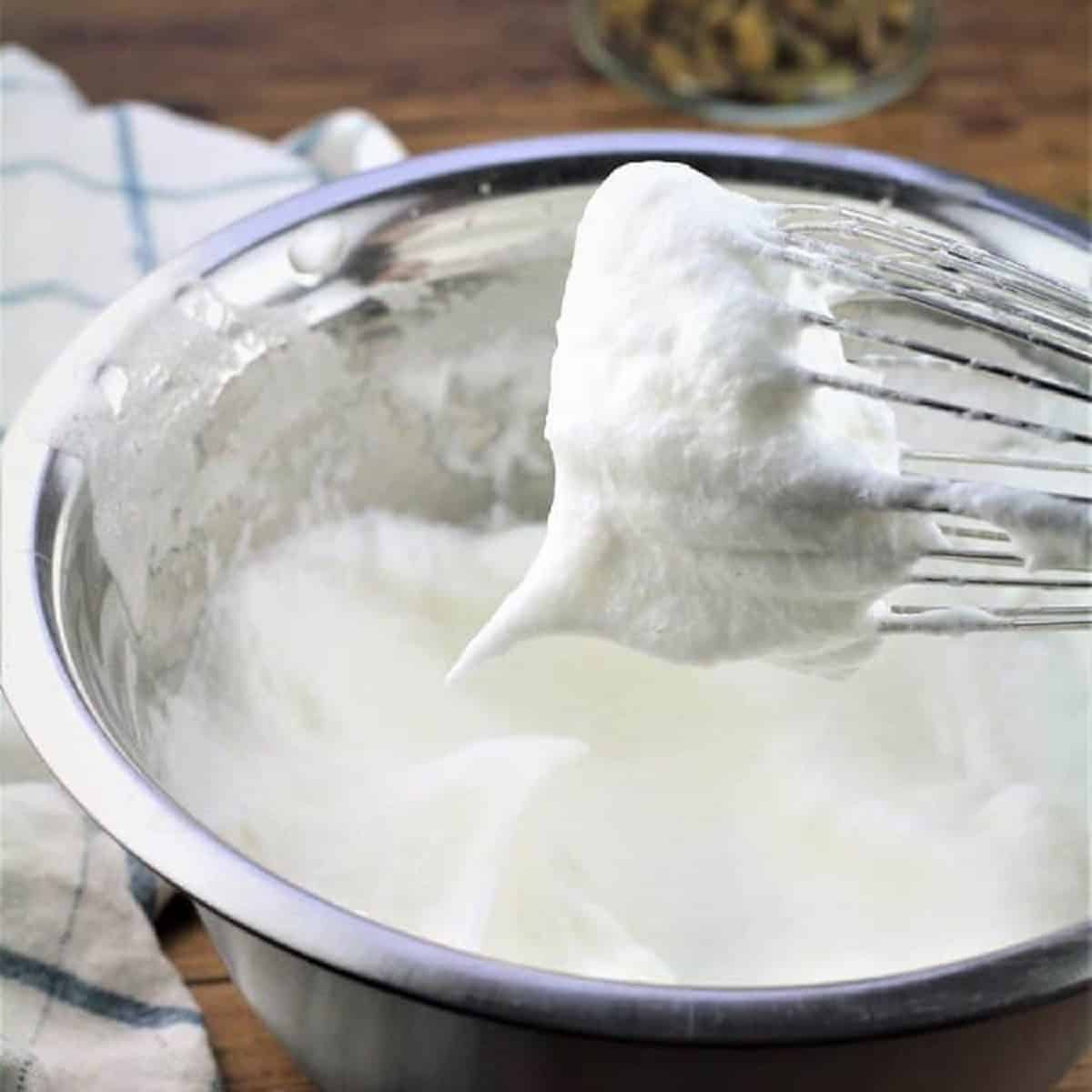 Whisked egg whites until stiff in bowl.