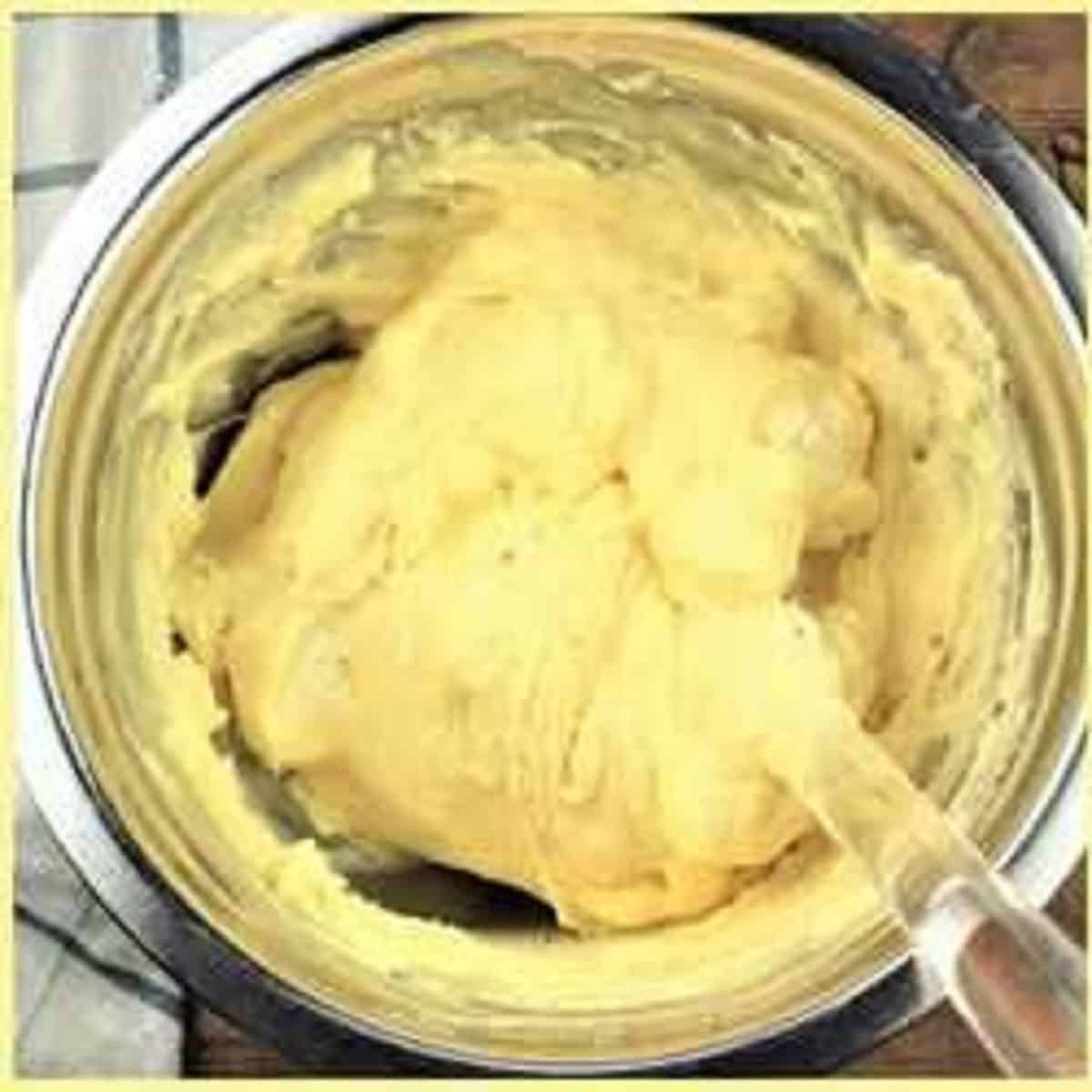 Mascarpone cream stirred into bowl with egg yolks and sugar.