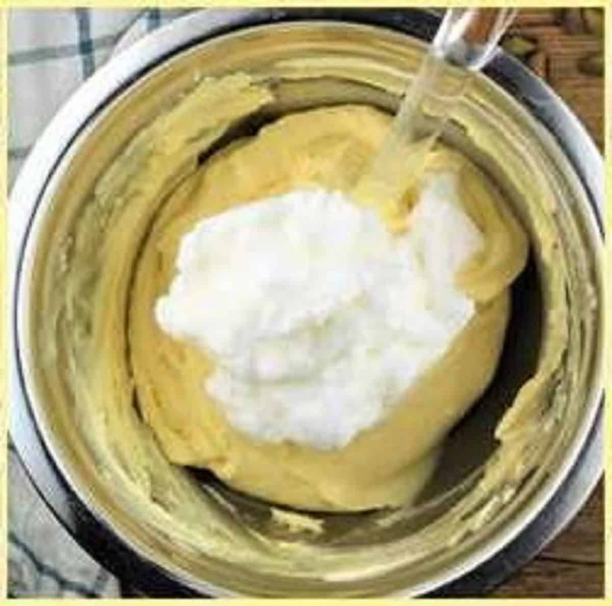 Egg whites folded into bowl with egg yolks and mascarpone cream.