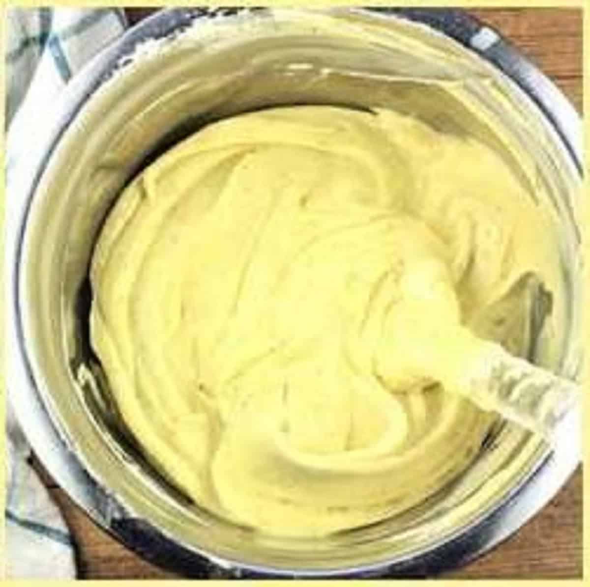 Pistachio butter stirred into mascarpone cream mixture for tiramisu recipe.