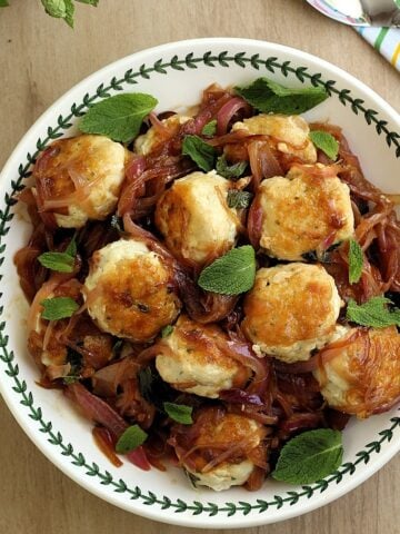 Bolw filled with Sicilian swordfish meatballs in sweet and sour sauce topped with mint leaves.