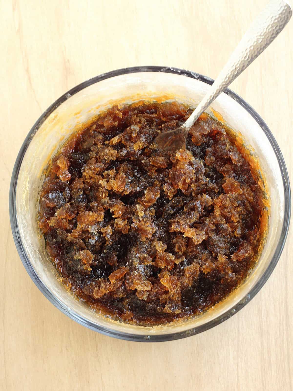 Coffee granita semi frozen in glass container with fork to scrape it.