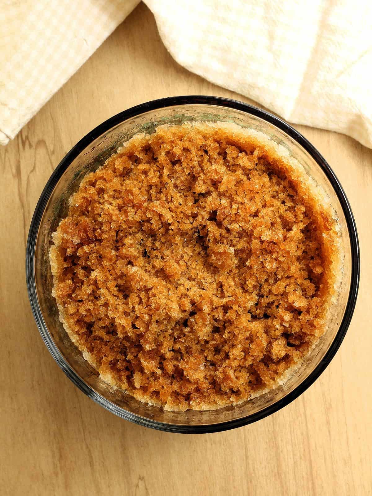 Scraped coffee granita shavings in glass container.