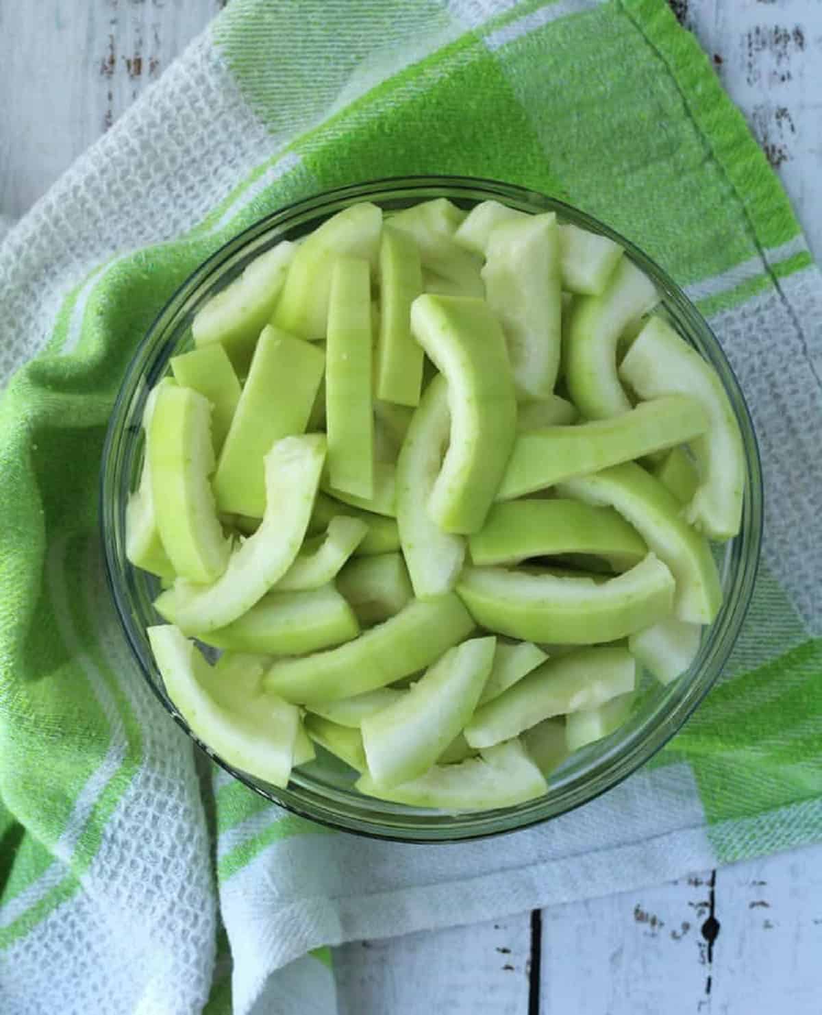 Cucuzza squash cut into slices in bowl.