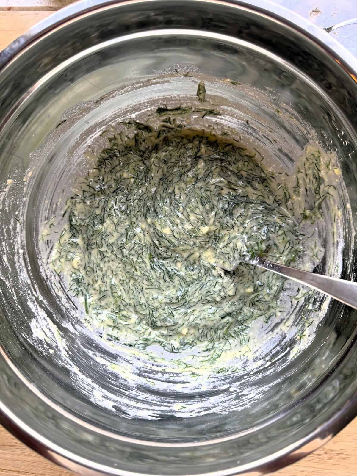 Wild fennel fritters batter stirred in large bowl.