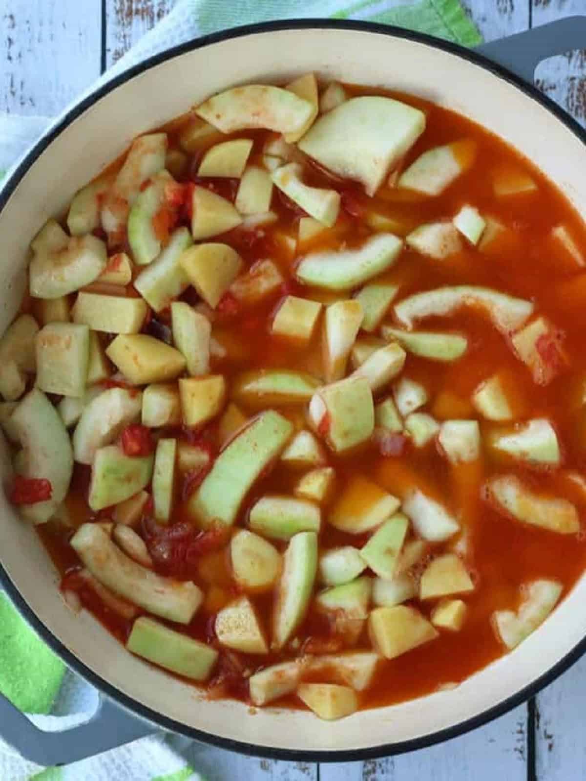 Water added to skillet with Sicilian cucuzza, tomato and onion.