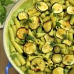 Skillet filled with pasta with zucchini 2 ways: zucchini pesto and oven roasted zucchini.