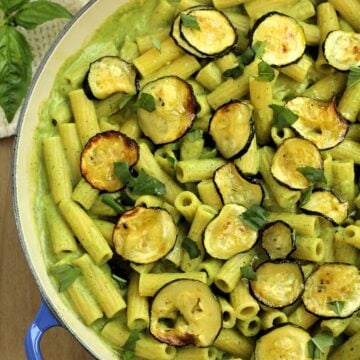 Skillet filled with pasta with zucchini 2 ways: zucchini pesto and oven roasted zucchini.