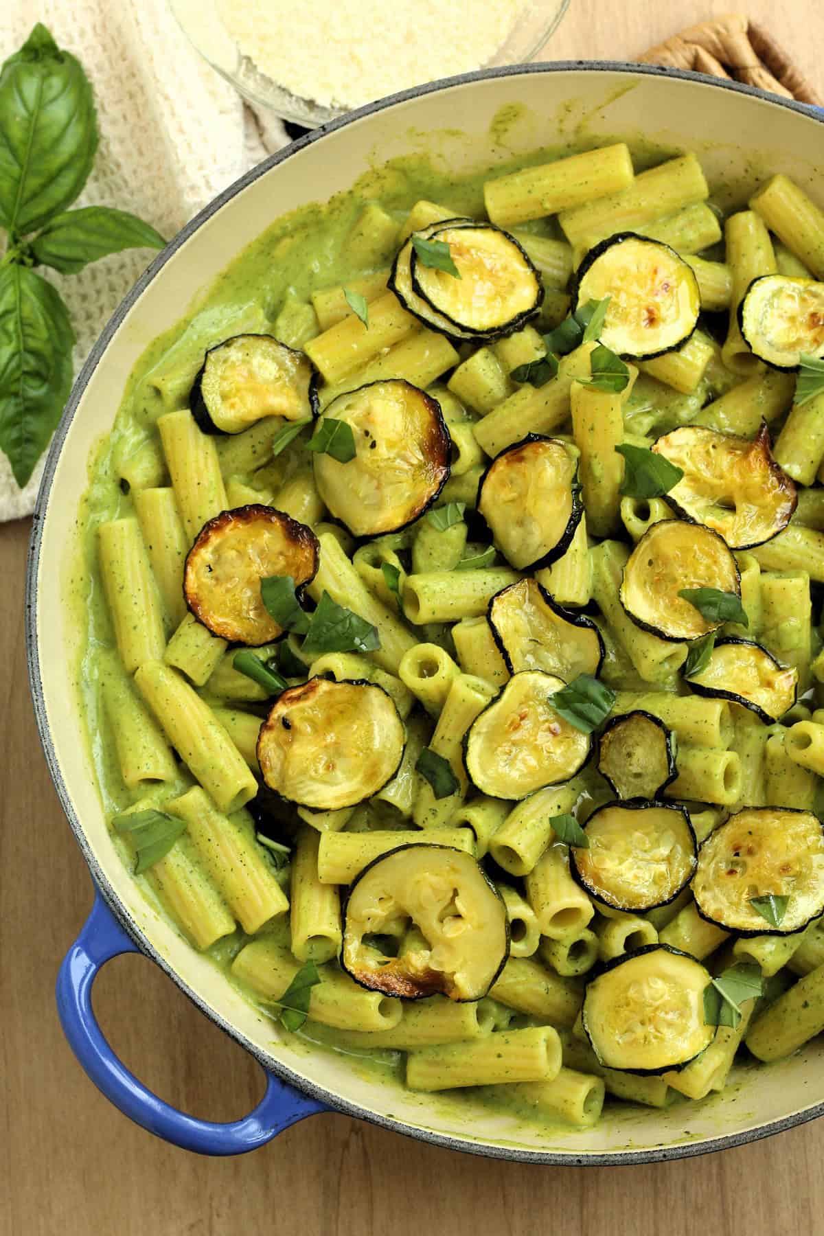 Skillet filled with pasta with zucchini 2 ways: zucchini pesto and oven roasted zucchini.