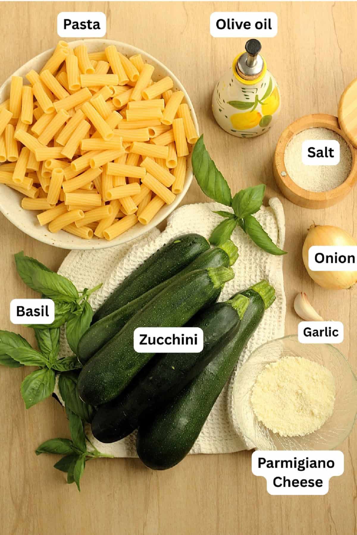 Pasta, zucchini, oil, salt, onion, garlic, grated cheese and basil.
