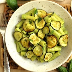 Bowl filled with pasta with zucchini 2 ways, zucchini pesto and oven roasted zucchini.