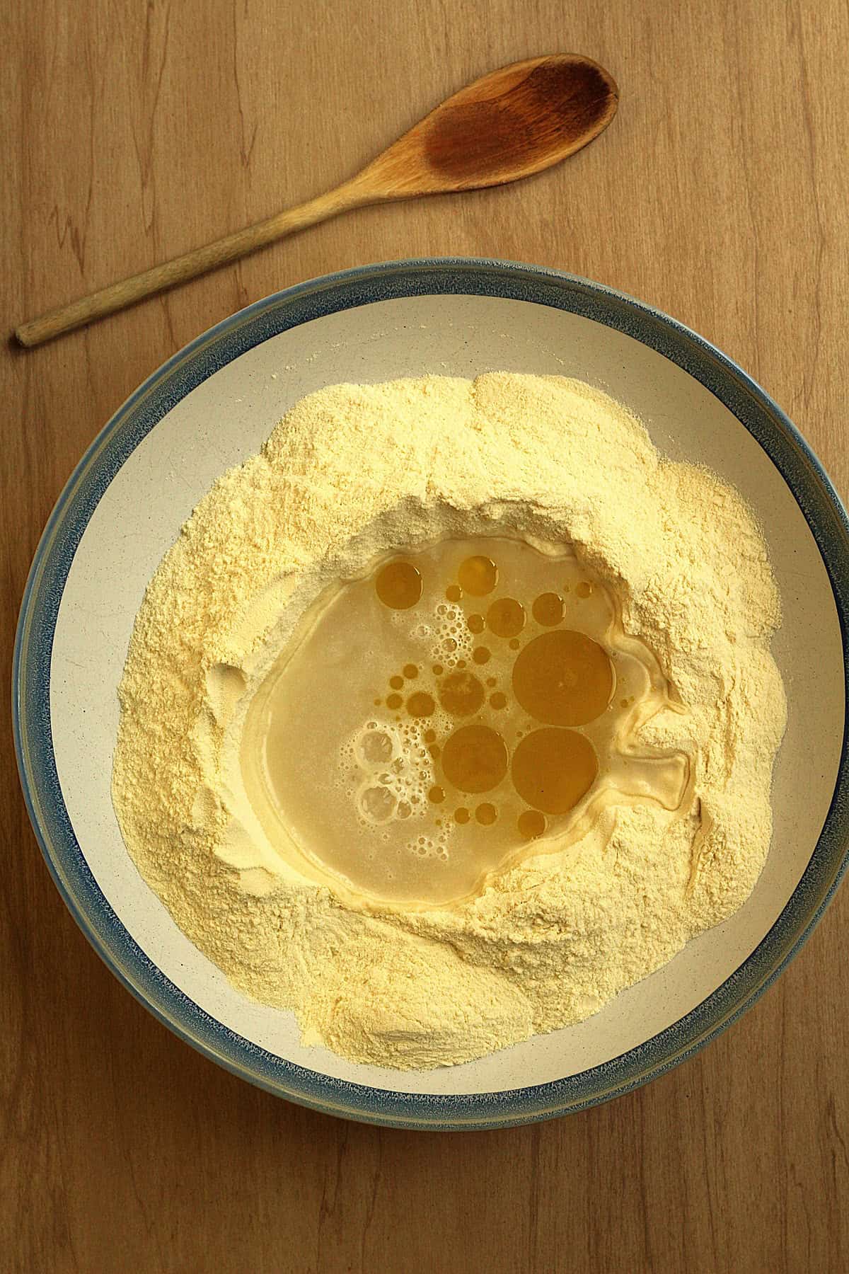 Semolina flour with well in the center and yeast mixture and olive oil poured in.
