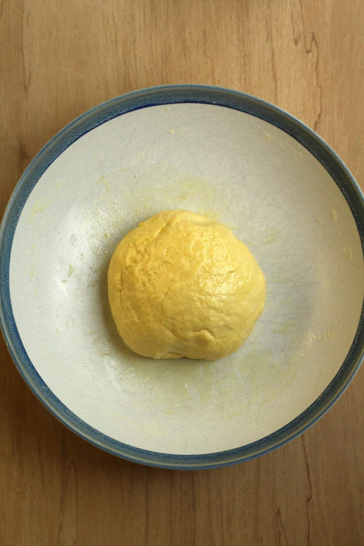 Transfer the dough and knead until smooth and elastic, about 7-8 minutes. Place the dough in a greased bowl and cover with plastic wrap.