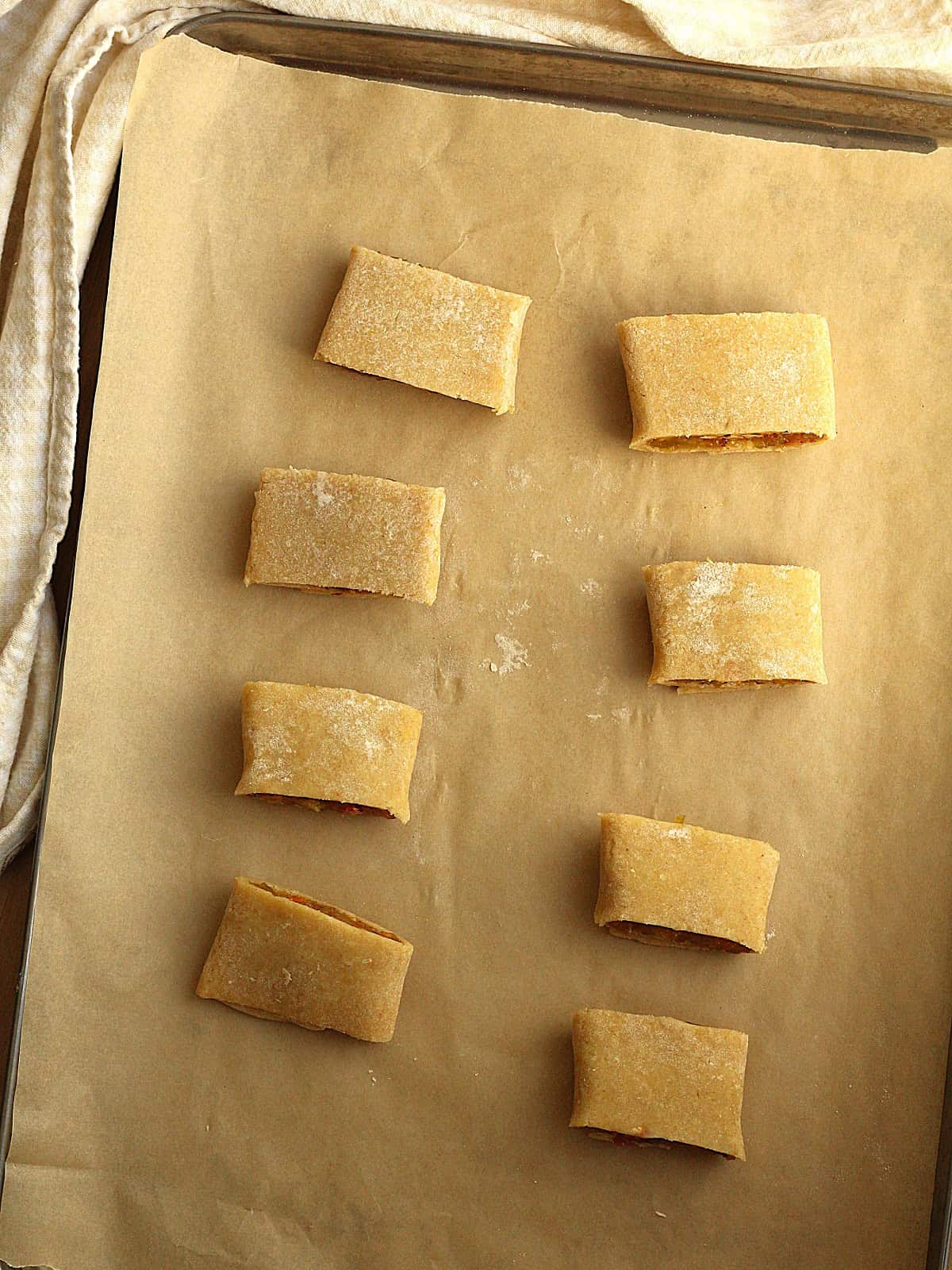 Settembrini cookies cut into individual servings on baking sheet to be baked.