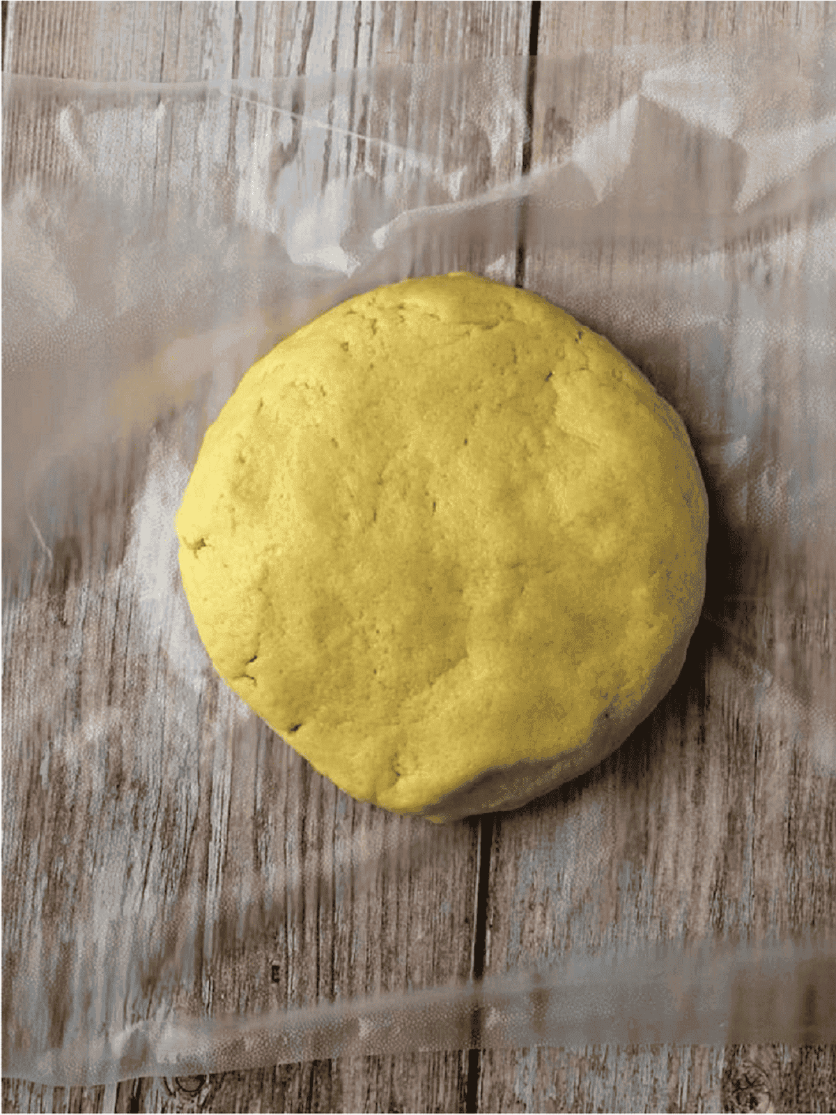 Shortbread dough shaped into a disc for fig jam cookies.