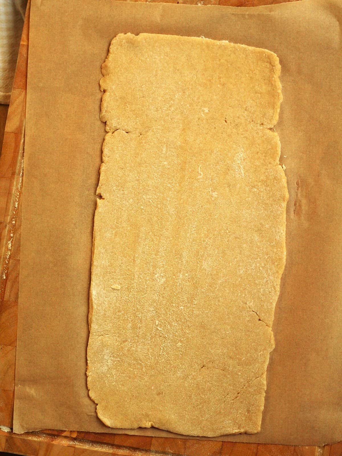 Pasta frolla dough rolled into rectangular shape for fig jam cookies.
