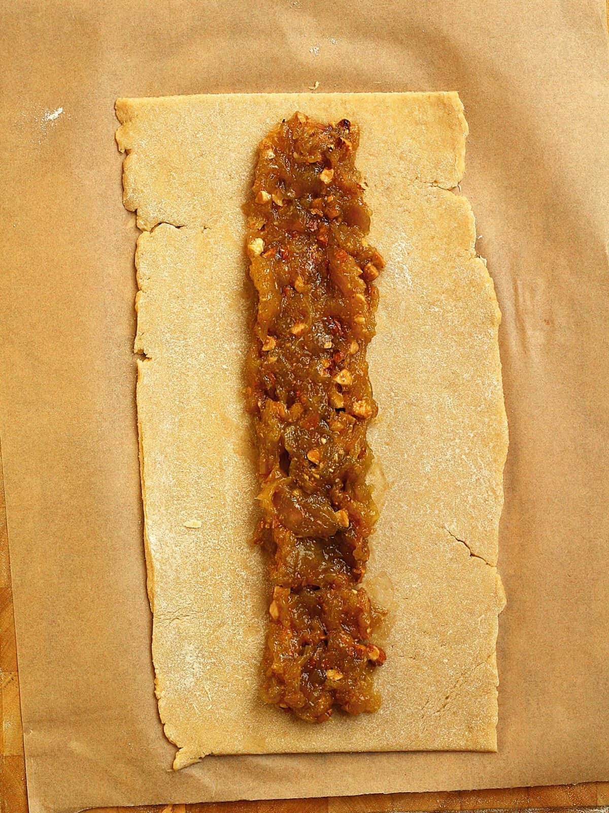 Fig jam spread along center of shortbread dough for settembrini cookie recipe.