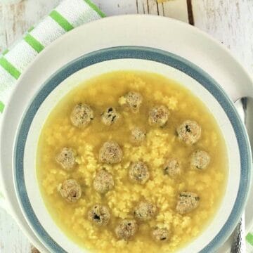 Pastina soup with tiny meatballs in bowl.